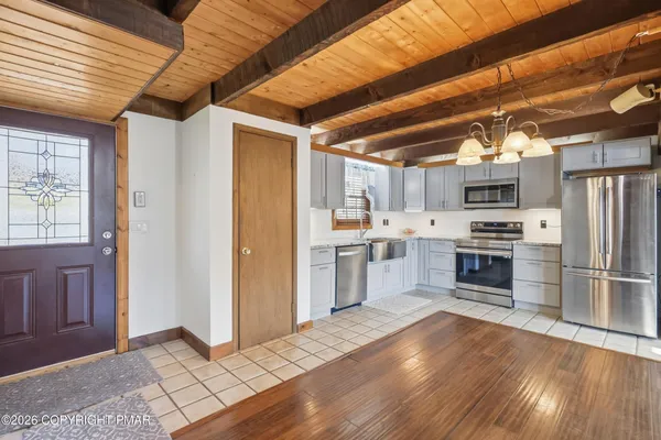 a kitchen with stainless steel appliances a refrigerator and a stove