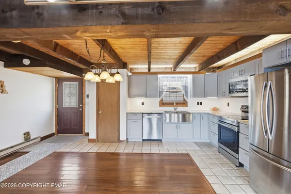 a kitchen with stainless steel appliances a stove sink and cabinets