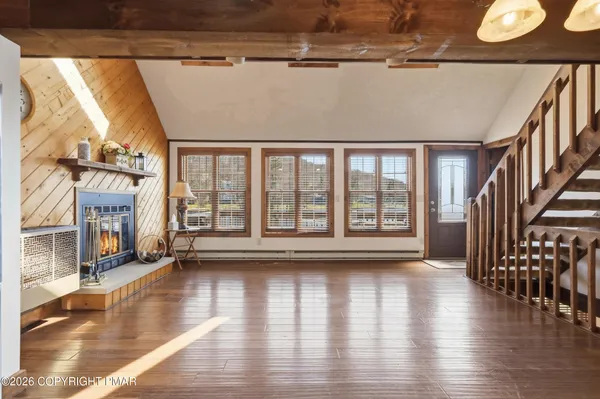 a view of an entryway with wooden floor