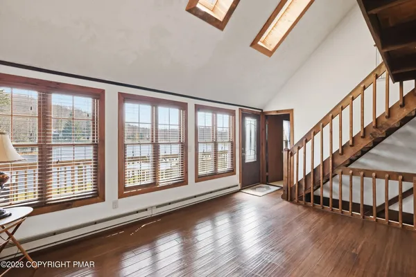a view of an entryway with wooden floor