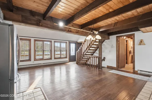 a view of hallway with stairs and wooden floor