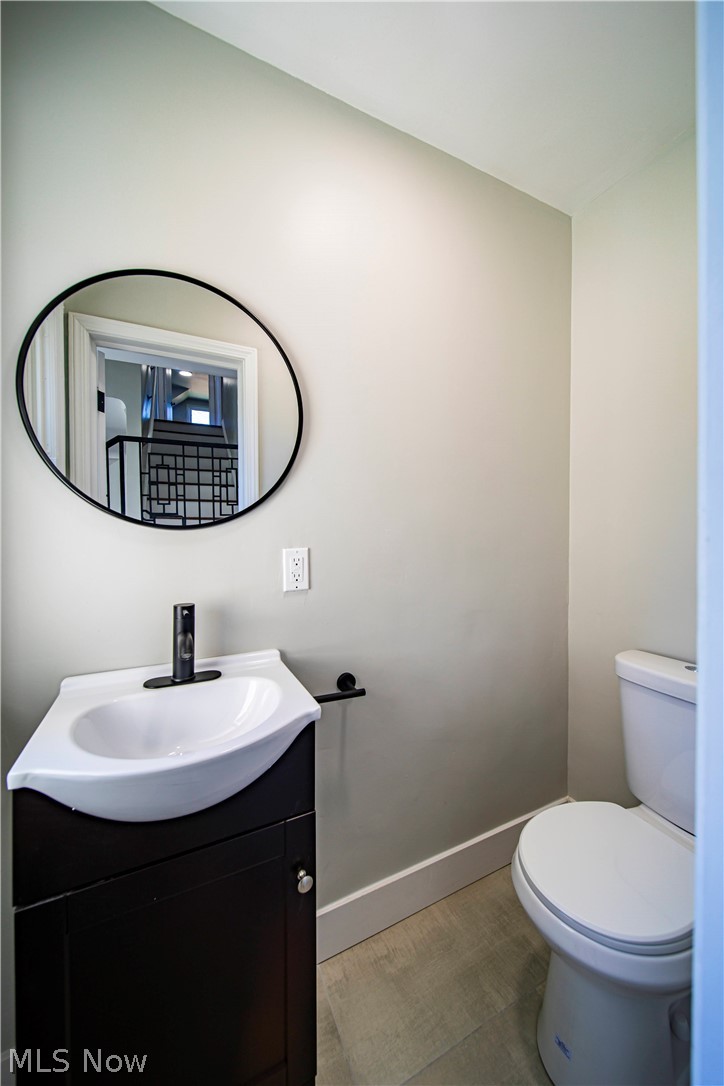 9412 Oakdale Road Parma, OH 44129 - Photo 11 of 38 Bathroom featuring toilet, vanity, and hardwood / wood-style floors