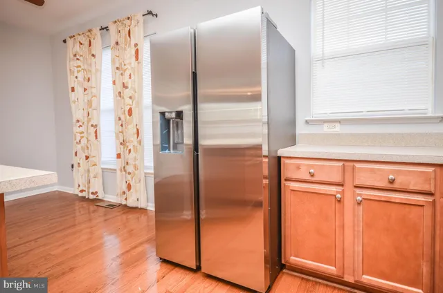 a kitchen with stainless steel appliances granite countertop a sink and cabinets