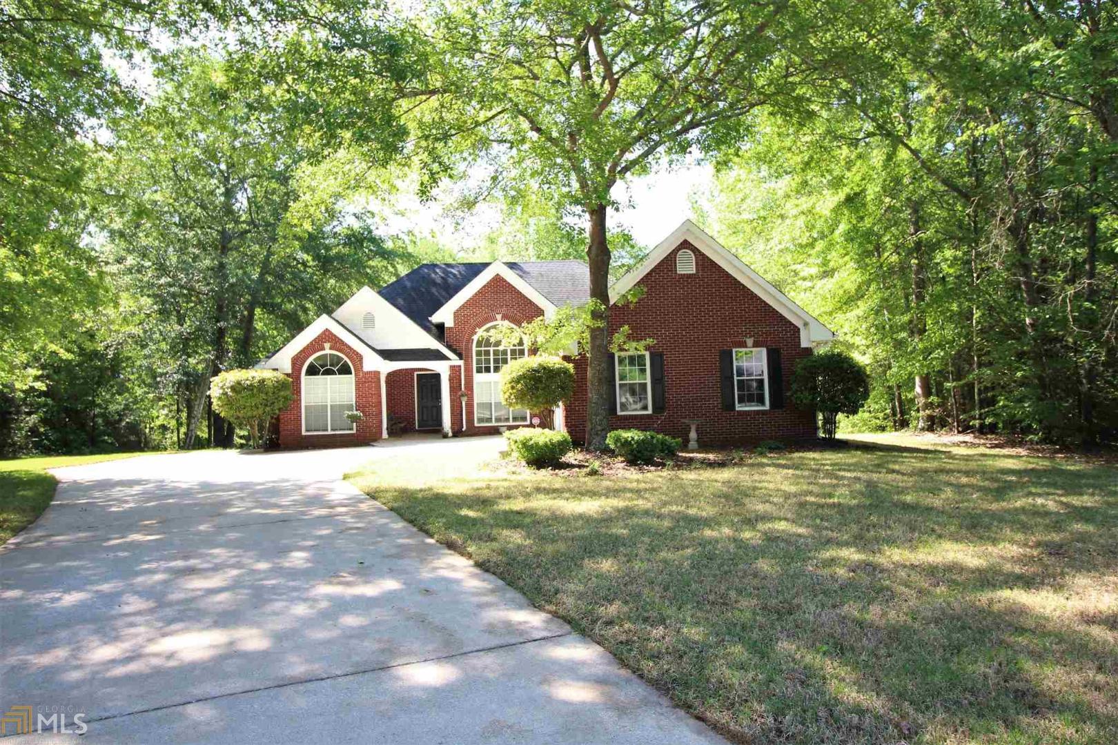185 Gibson Way Covington, GA 30016 - Photo 1 of 1 a front view of a house with a yard and garage