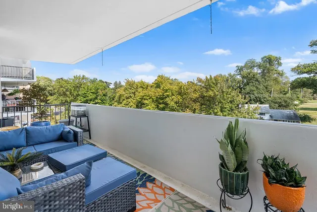 a view of a chairs and table in a balcony