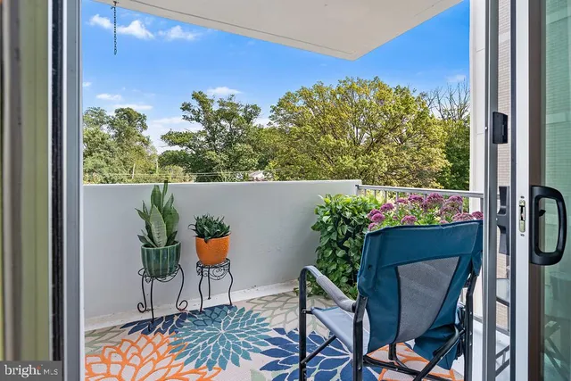a living room with furniture a piano and a bookshelf