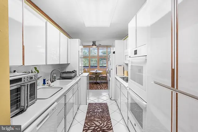 a kitchen with a sink stove and refrigerator
