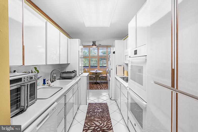 7301 Coventry Avenue, Unit 502 Elkins Park, PA 19027 - Photo 8 of 16 a kitchen with a sink stove and refrigerator