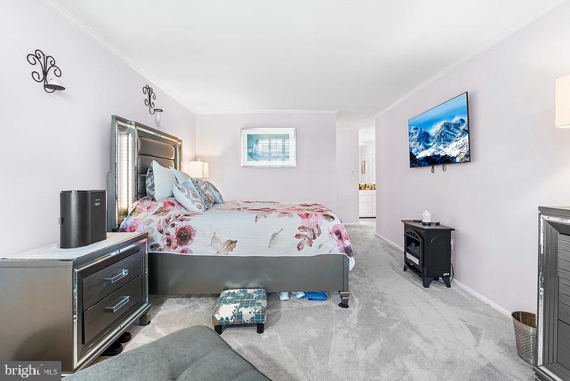 7301 Coventry Avenue, Unit 502 Elkins Park, PA 19027 - Photo 10 of 16 a bed sitting in a bedroom next to a window