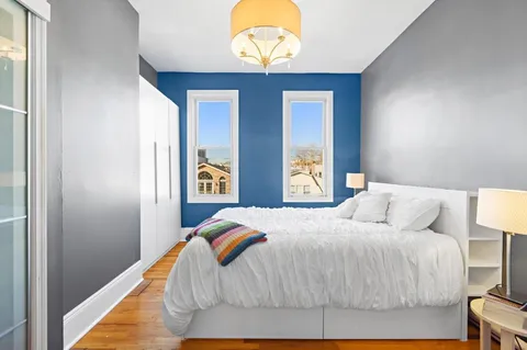 a bedroom with a bed and window