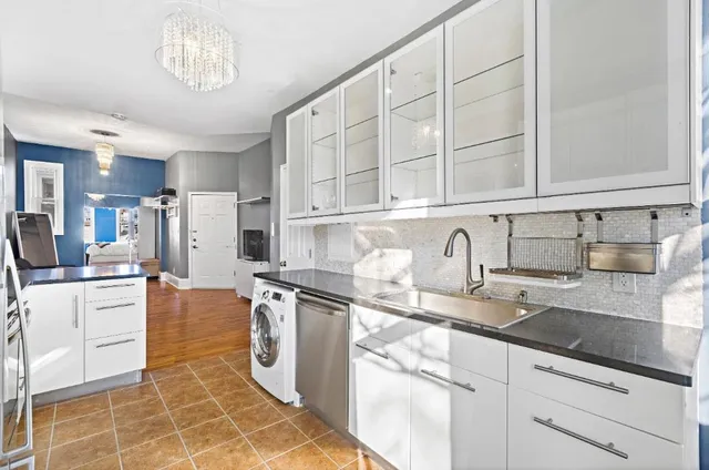 a kitchen with stainless steel appliances granite countertop a sink a stove and cabinets