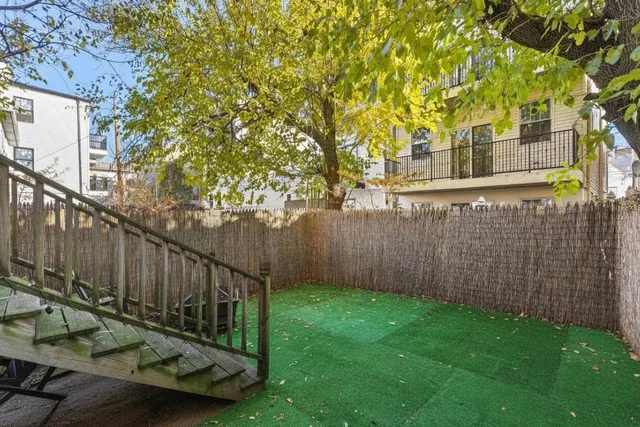 a view of a chair and table in the backyard