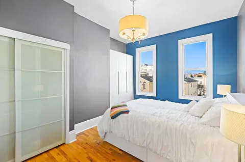 a bedroom with a bed and a chandelier