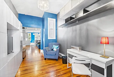 a living room with furniture and a wooden floor
