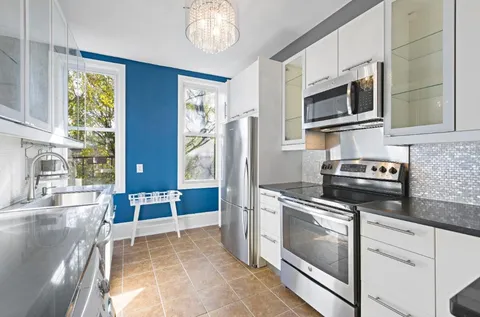 a kitchen with stainless steel appliances granite countertop a stove and a microwave