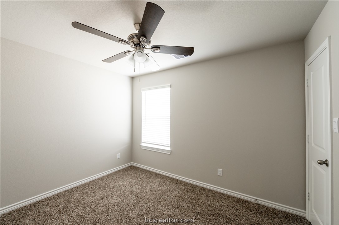 2159 Chief Street Bryan, TX 77807 - Photo 10 of 22 an empty room with a window and a fan