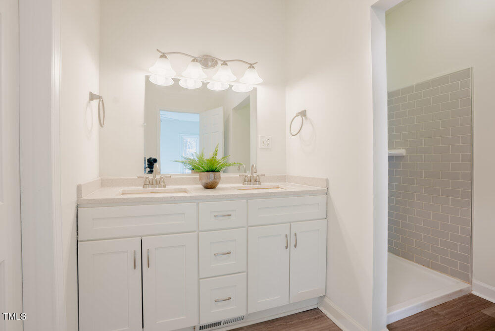 1514 Wiljohn Road Garner, NC 27529 - Photo 17 of 46 a bathroom with a double vanity sink and a mirror