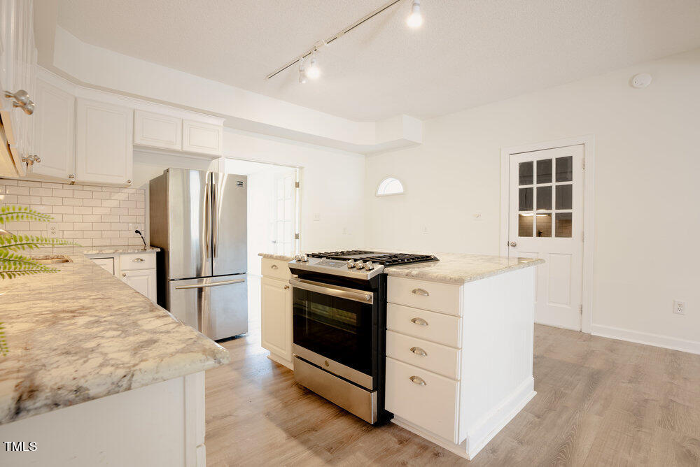 1514 Wiljohn Road Garner, NC 27529 - Photo 8 of 46 a kitchen with a stove a refrigerator and a sink