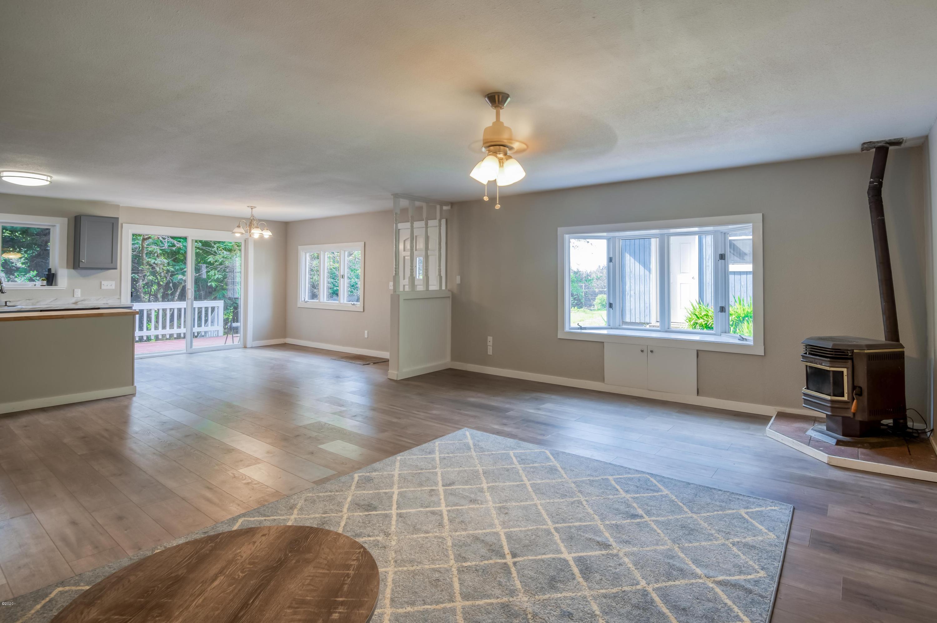 3038 Northeast East Line Road Yachats, OR 97498 - Photo 11 of 24 a view of an empty room with window and wooden floor