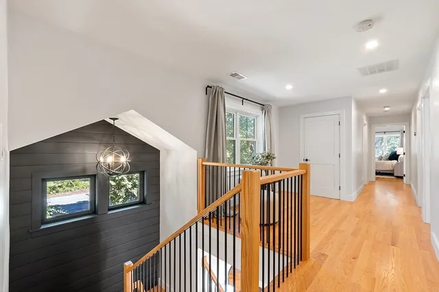a view of a hallway view with wooden floor and staircase