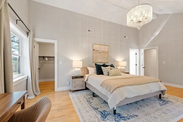 a bedroom with a bed and a chandelier