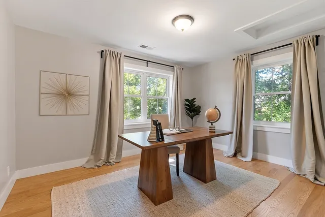 a work room with furniture and large windows