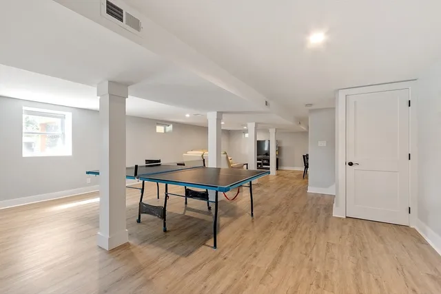 a view of a room with wooden floor windows and wooden floor