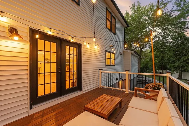 a view of a roof deck with two couches and wooden floor