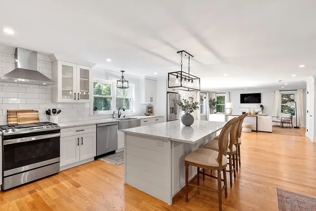 a kitchen with a table chairs stove and microwave