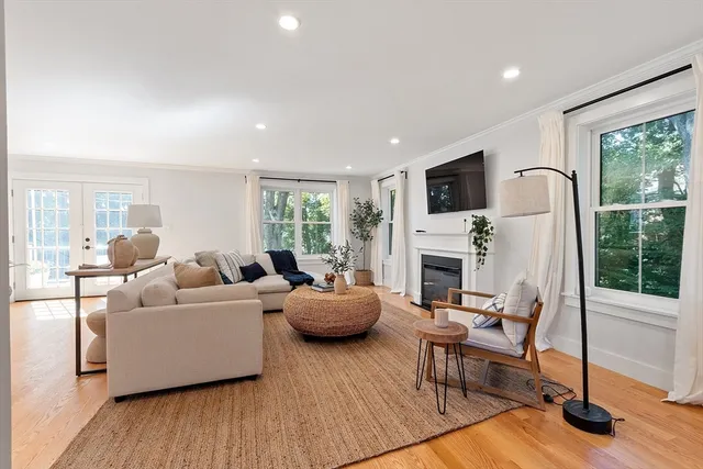 a living room with fireplace furniture and a flat screen tv