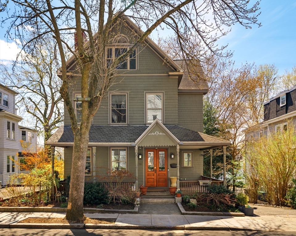 a front view of a house with yard porch and glass windows