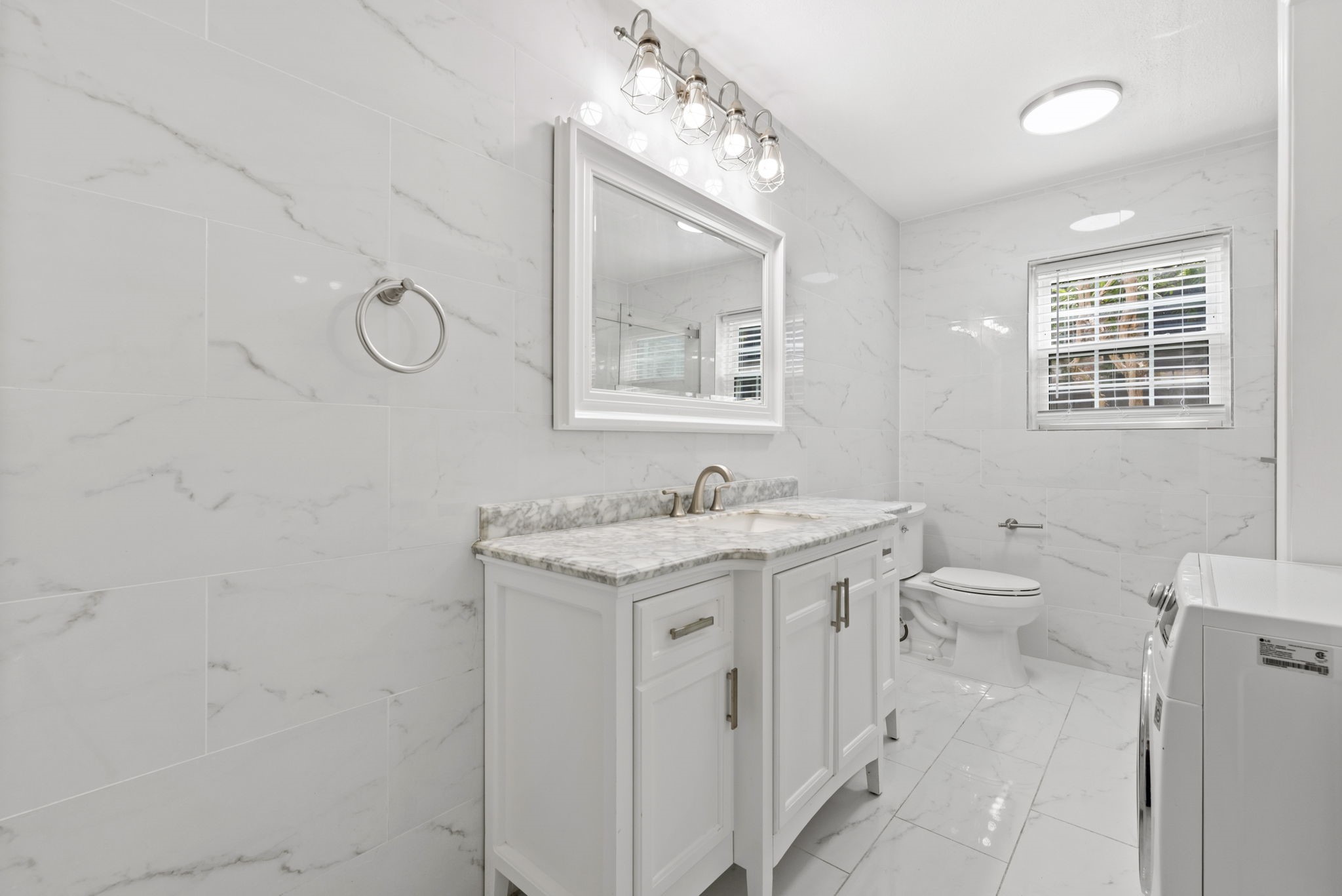 7900 Westheimer Road, Unit 121 Houston, TX 77063 - Photo 21 of 23 a spacious bathroom with a granite countertop sink a toilet and a mirror