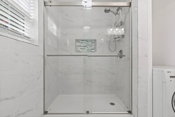 a bathroom with a sink a mirror and a shower