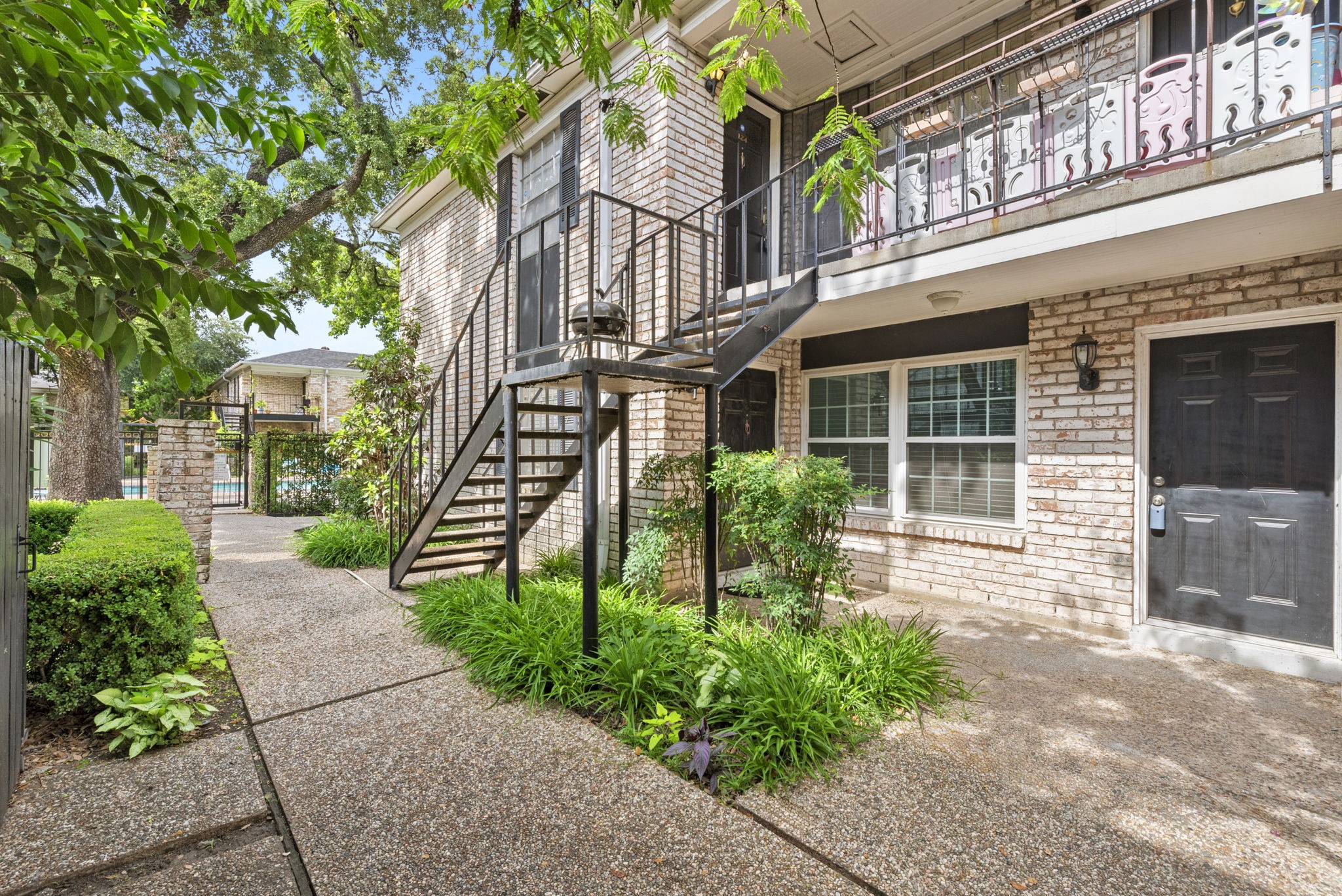 7900 Westheimer Road, Unit 121 Houston, TX 77063 - Photo 3 of 23 a front view of a house with a garden
