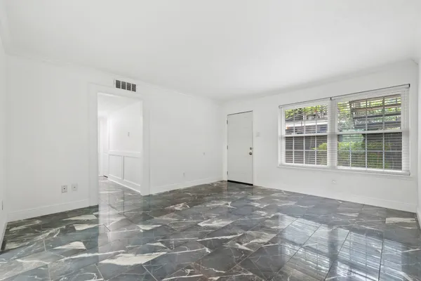 a view of an empty room with a window