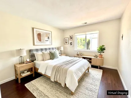 a bathroom with a granite countertop sink a toilet a large mirror and vanity