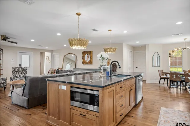 a kitchen with stainless steel appliances granite countertop a stove and a sink