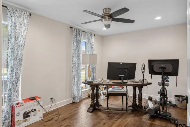 a view of a workspace with furniture and wooden floor