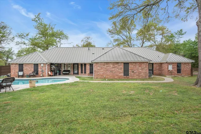 a house view with a seating space and garden