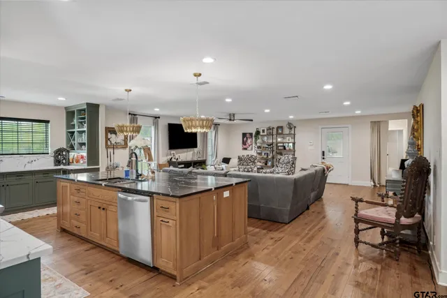 a kitchen with kitchen island granite countertop lots of counter top space and living room