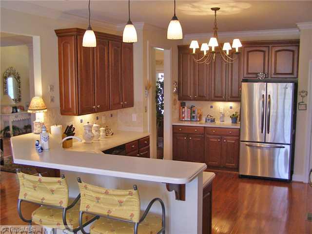 602 Stafford Pointe Court Oak Ridge, NC 27310 - Photo 4 of 16 Kitchen. Entertainer s kitchen with solid surface counters and sit-up bar area
