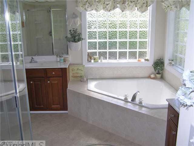 602 Stafford Pointe Court Oak Ridge, NC 27310 - Photo 6 of 16 Master Bath/Spa. Separate tub and shower-separate vanities-tile floors-separate closets