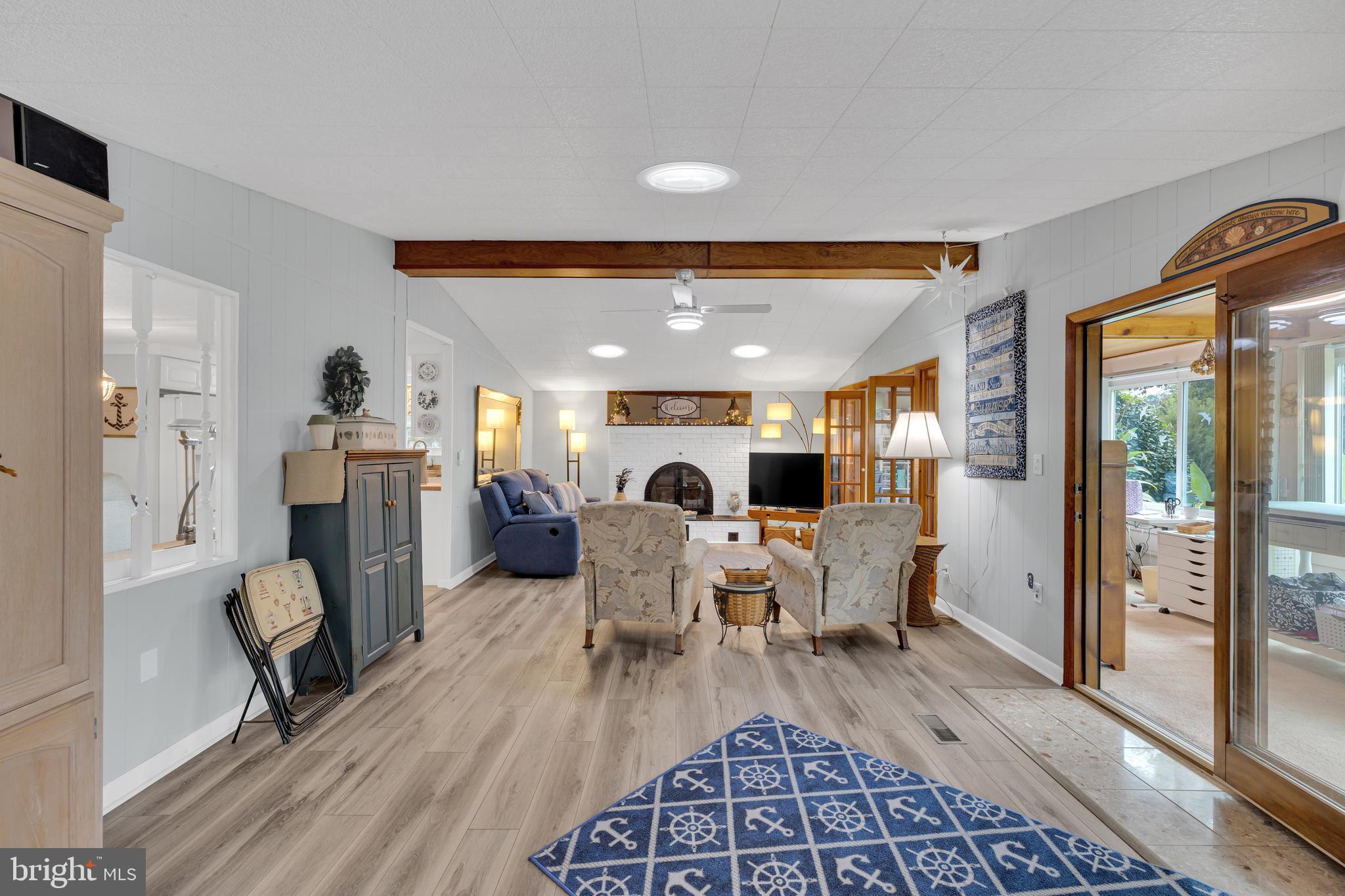 30879 Maplewood Road Ocean View, DE 19970 - Photo 13 of 41 a living room with furniture and a fireplace