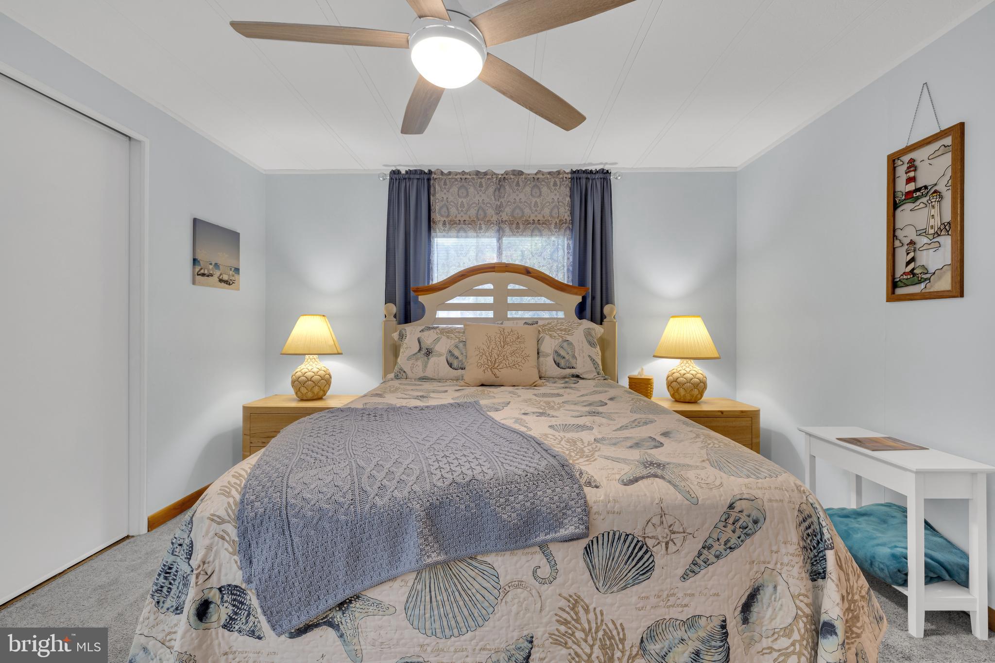 30879 Maplewood Road Ocean View, DE 19970 - Photo 22 of 41 a bedroom with a bed and a chandelier