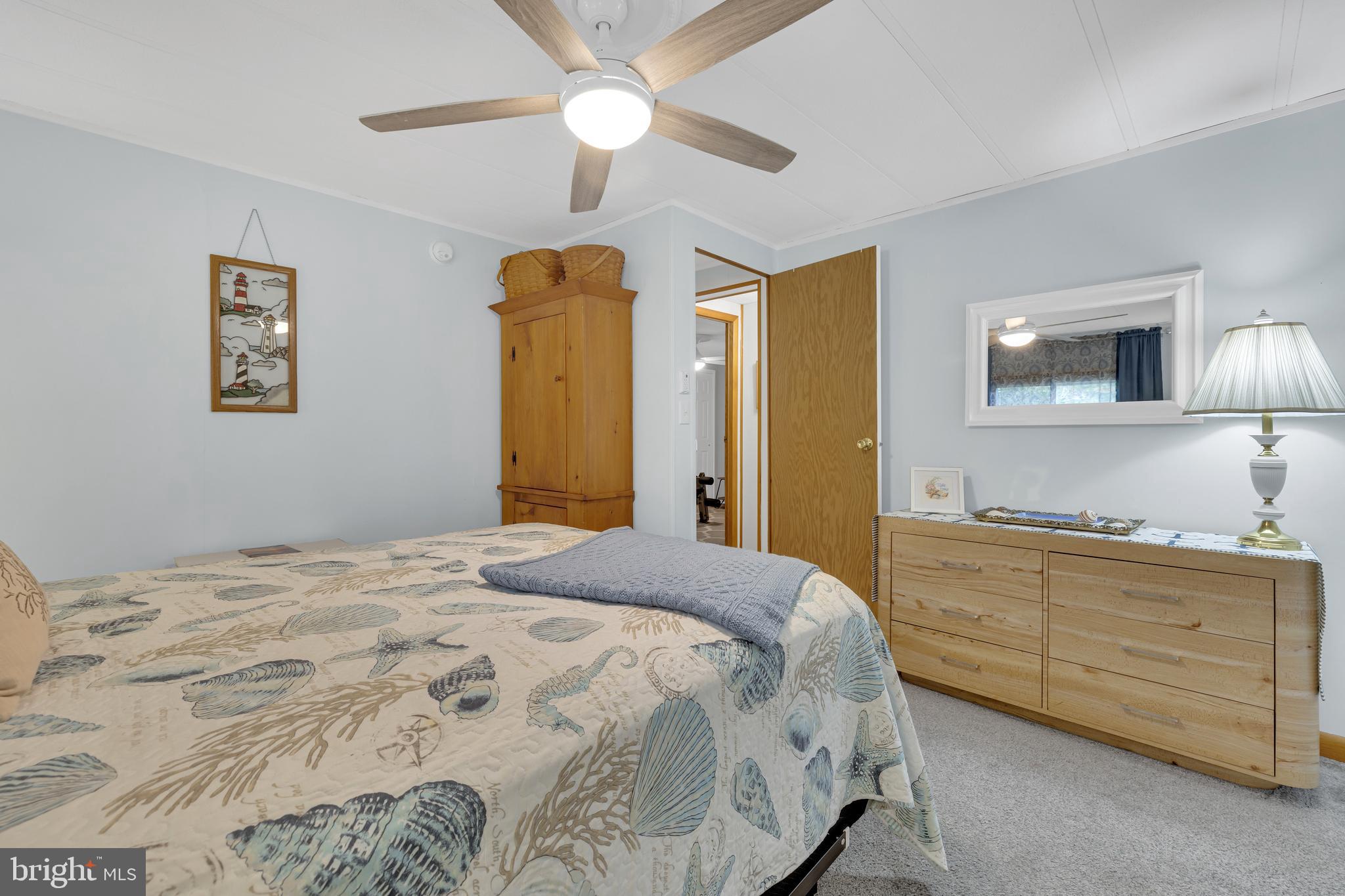 30879 Maplewood Road Ocean View, DE 19970 - Photo 23 of 41 a bedroom with a bed and a flat screen tv