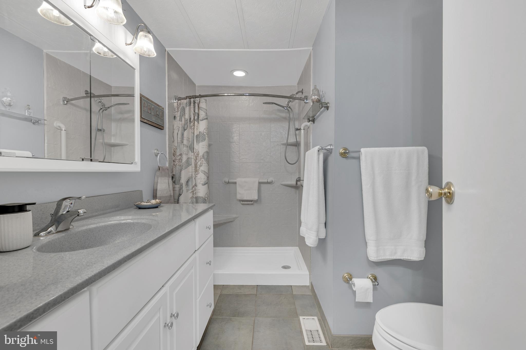 30879 Maplewood Road Ocean View, DE 19970 - Photo 24 of 41 a bathroom with a sink toilet and shower