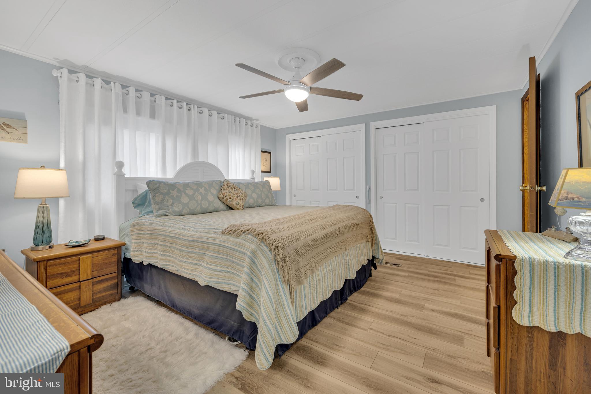 30879 Maplewood Road Ocean View, DE 19970 - Photo 25 of 41 a bedroom with a bed and a chandelier