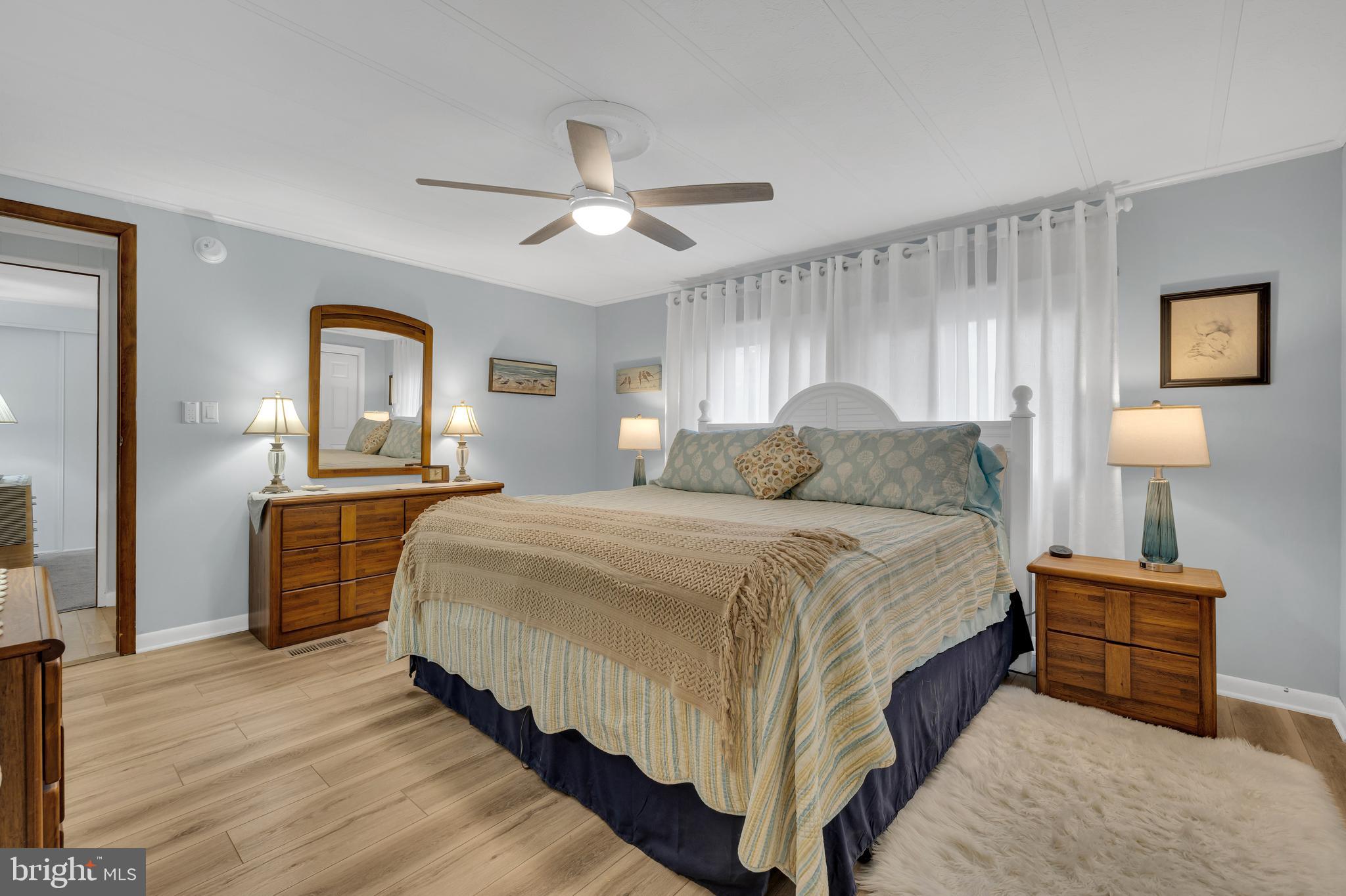 30879 Maplewood Road Ocean View, DE 19970 - Photo 26 of 41 a bedroom with a bed and a chandelier