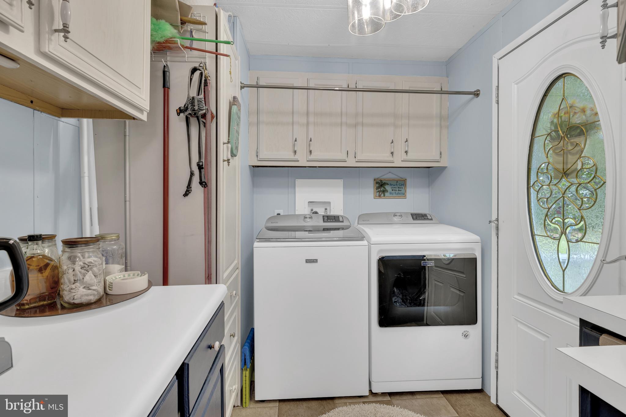 30879 Maplewood Road Ocean View, DE 19970 - Photo 30 of 41 a utility room with stainless steel appliances granite countertop a white stove top oven and sink