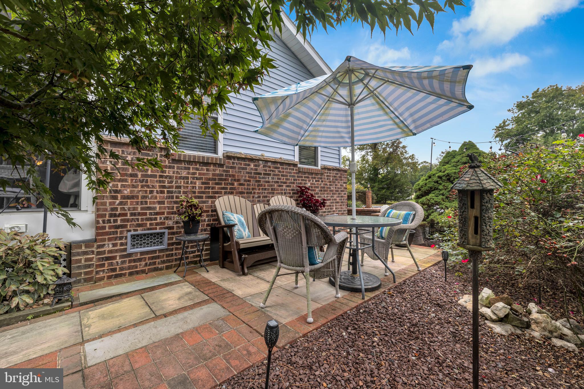 30879 Maplewood Road Ocean View, DE 19970 - Photo 33 of 41 a patio with table and chairs and potted plants